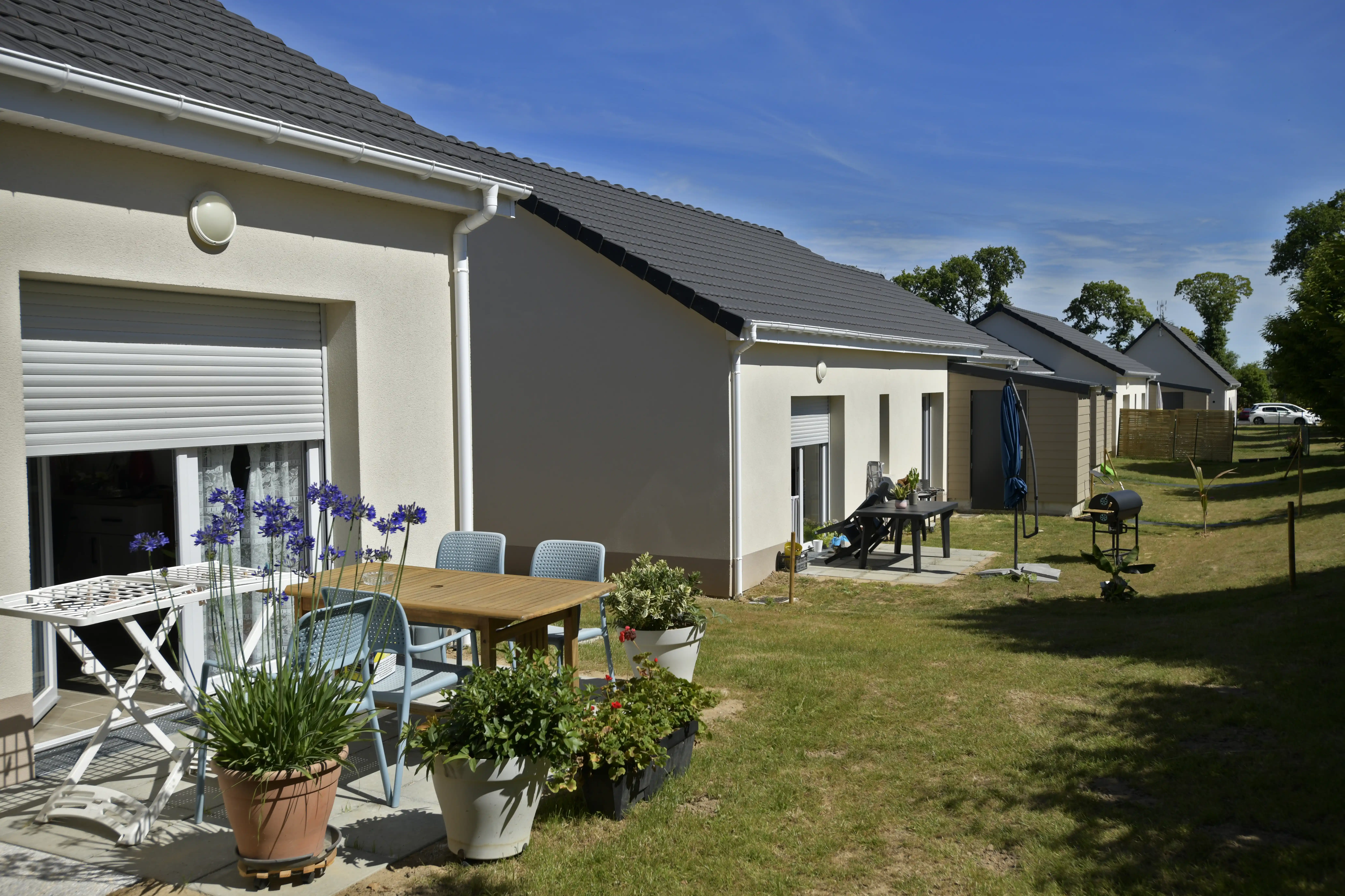 Maison avec jardin et salon de jardin, ensoleillé